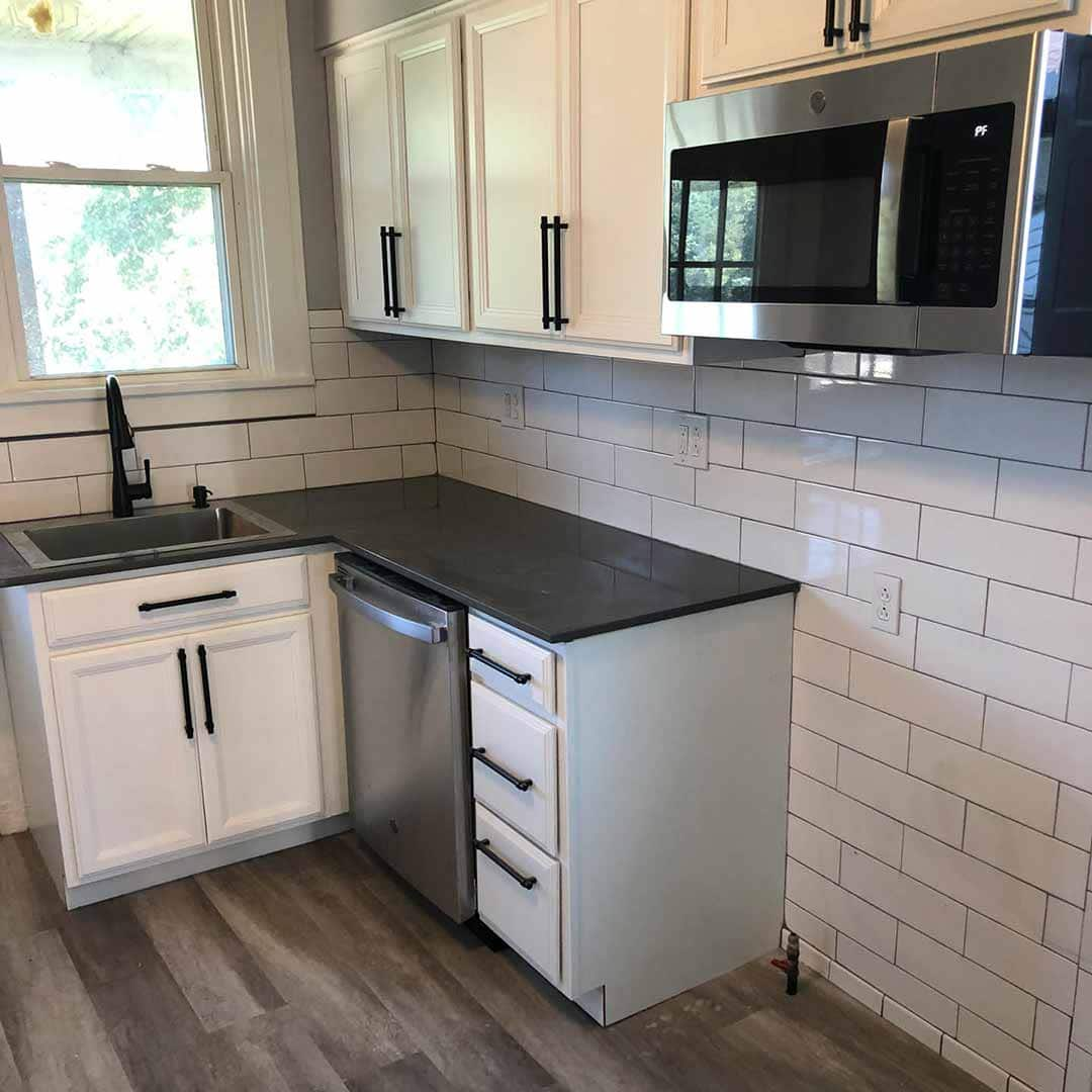 New black and white kitchen remodel with white subway tile backsplash