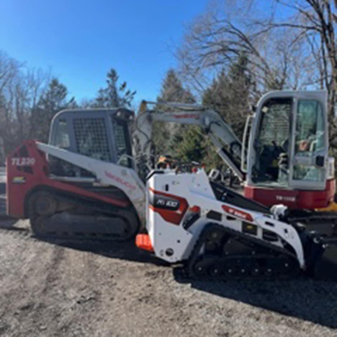 Red company truck and white Bobcat excavator